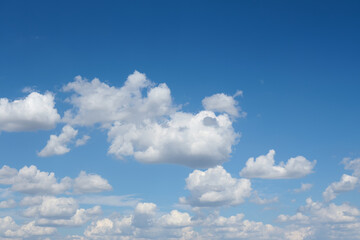 Large white beautiful clouds against the blue sky during the day.