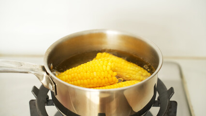 Jagung manis rebus or boiled sweet corn on stainless pan