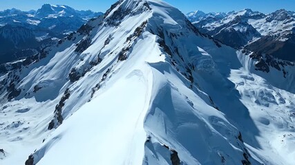 Cinematic aerial view of a majestic snow-covered mountain ridge, showcasing sharp icy peaks under a brilliant blue sky, conveying epic alpine grandeur and serene wilderness. - Powered by Adobe