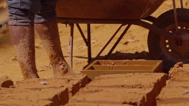 Construction worker making adobe bricks using traditional methods in Chapada dos Veadeiros, promoting sustainable building practices and cultural preservation