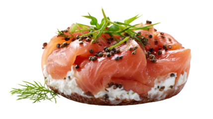 Close-up of a mini bagel with cream cheese and slices of salmon, sprinkled with cumin seeds and dill leaves on top, isolated on transparent background.