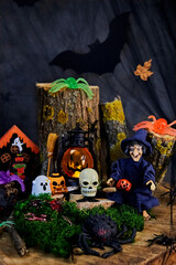 halloween fun on all saints eve - skulls, ghosts, pumpkins, spiders and other halloween characters in a dark forest late at night in a witch's house, selective focus