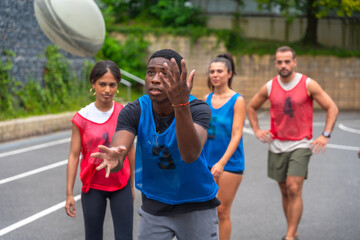 Rugby player catching ball during training with teammates