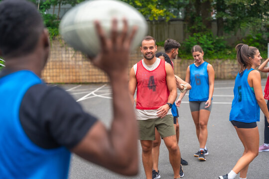 Rugby players passing ball during training outdoors