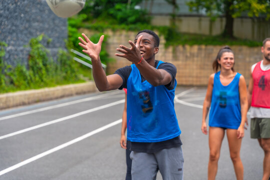 Rugby player catching ball during training with teammates