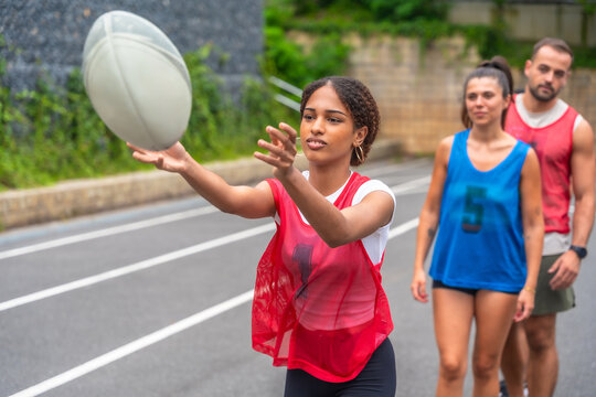 Female rugby player passing the ball during training on the field