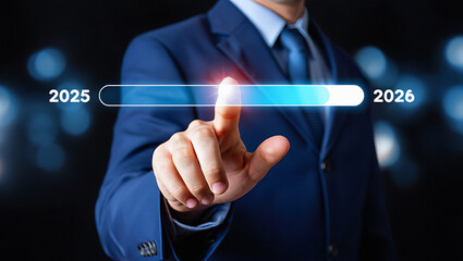 Businessman's finger interacts with glowing progress bar advancing from 2025 towards 2026 symbolizing future planning and forward movement