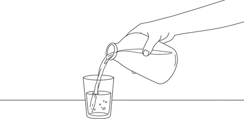 Fototapeta premium a hand pouring liquid from one glass into another