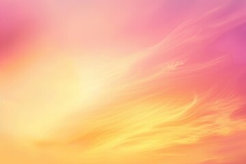Obraz premium Vibrant sunset sky with soft clouds blending hues of pink, orange, and yellow, creating a serene atmosphere