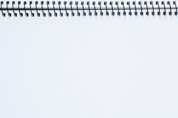 close up of blank white page of sketchbook with spiral binder