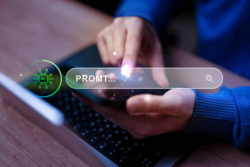 Searching for information using a smartphone while working on a laptop in a modern workspace