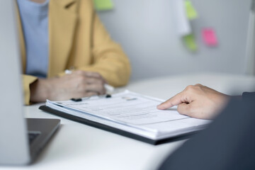 Business people hold a resume and talk to job applicants for job interviews about careers and Their personal history in the company. Recruitment concepts