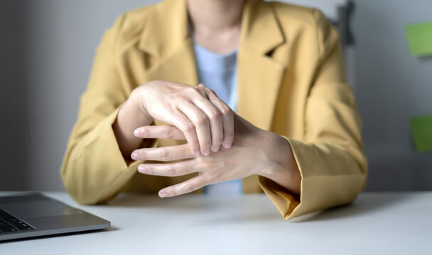 Woman hand with wrist pain numbness and pain in the palm of the hand has pain and tingling in the nerve endings This is a side effect of sitting and working for a long time on a laptop at the office