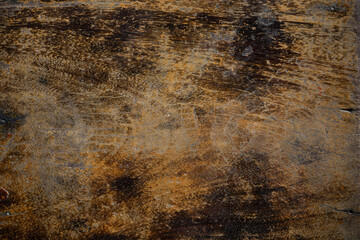 A grunge texture background showing a close-up of a heavily scratched and weathered old wooden surface.