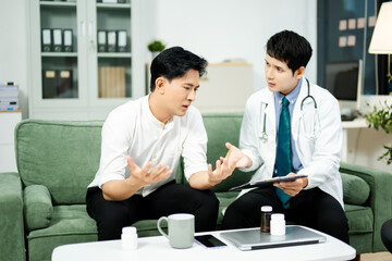 Doctor consulting with a stressed male patient in private clinic. Mental health care, therapy, empathy, and emotional support