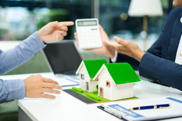 Real estate broker agent presenting and consult to customer to decision making sign insurance form agreement, home model