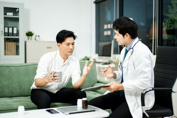 Caring doctor supports stressed male patient during mental health consultation on sofa. Therapy, empathy, and emotional care