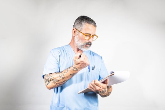 Doctor reading medical record and holding pen, thinking about diagnosis
