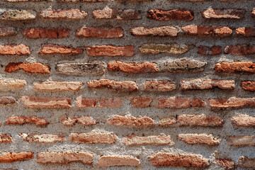 Brick wall with earthy tones showing texture and craftsmanship in a rustic setting