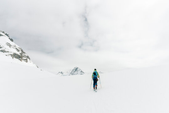A man skins up a hill in the backcountry.