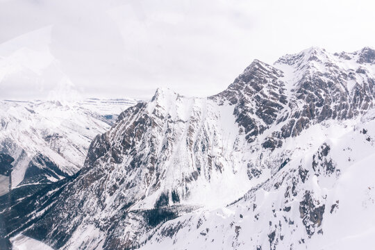 The Northern Rockies as seen through the glass of a helicopter.