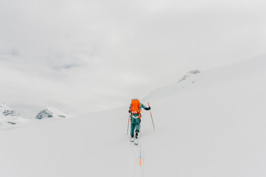A ski guide skins up a mountain in the backcountry.