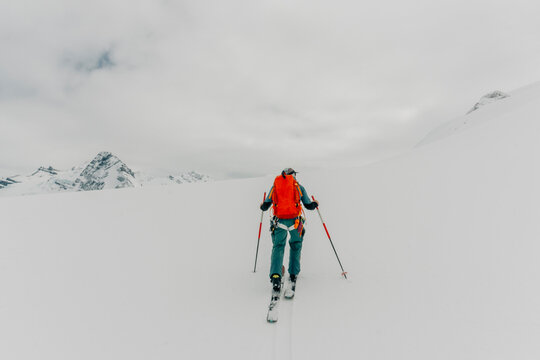 A guide skins up a mountain in the backcountry.