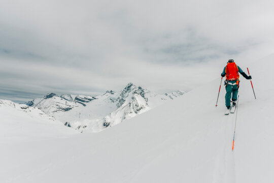 A ski guide skins up a mountain in the backcountry.