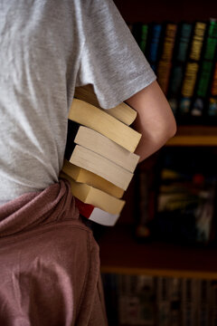 closeup stack of books, girl at the book shop library
