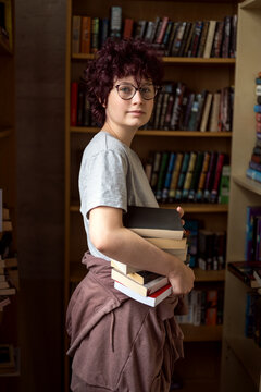 Young teen age girl wearing eye glasses at the book shop library