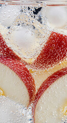 Close-up view of apple slices and ice cubes in sparkling water.