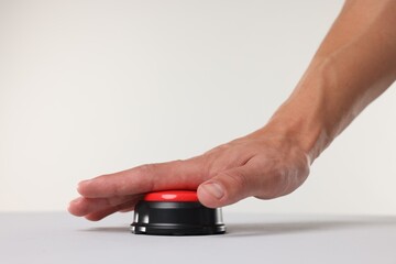 Fototapeta premium Man pressing red button on white background, closeup