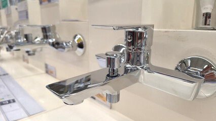 Modern chrome faucets displayed in elegant showroom setting