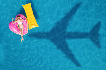Happy woman with inflatable mattress and ring in swimming pool, top view. Flying airplane casting...