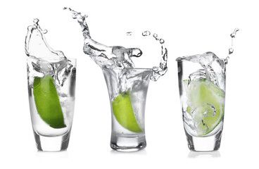Vodka in shot glasses with lime wedge isolated on white, set