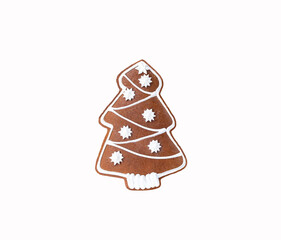 Christmas tasty ginger and honey  christmas tree shaped cookie with icing isolated on white background.