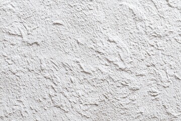 A white wall with a rough textured surface