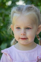 Sad little girl with allergy symptoms outdoors