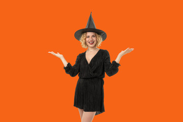 A person wearing a witch hat and black dress joyfully poses
