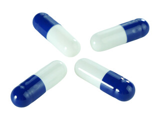 Bulk blue and white capsule pills isolated on white background.