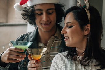 Young couple toasting during the Christmas brunch
