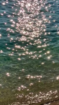 Sun reflects off the  water s surface. Vertical video.