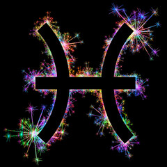 Kolorowe zimne ognie i fajerwerki układające się w kształt znaku zodiaku Ryby. © Blue Pixel