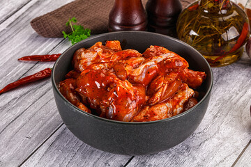 Raw marinated buffalo chicken wings