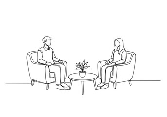 Professional meeting between two people in modern armchairs discussing ideas with a plant on a coffee table.