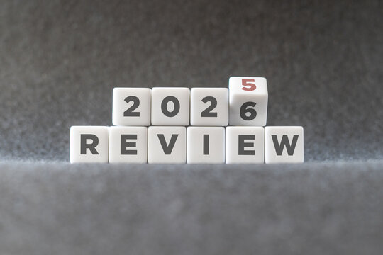 Flipping of 2025 to 2026 on white blocks. 2025 business and customer review for business strategic planning in the next year 2026. End of the year business concept