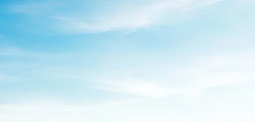 Light blue sky with soft white clouds gently fading to white at the bottom, creating a serene and airy atmosphere with subtle natural gradients and calm daylight. © al-sultan