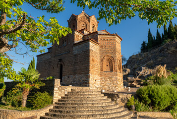 Horizontal photo of St. John's Church with its stairs and tree in the garden