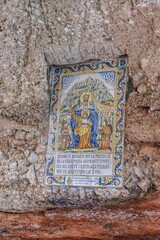 Traditional Ceramic Religious Tile With Virgin Mary And Child Jesus On Stone Wall In Montserrat Spain. Catalan Prayer Text, Pilgrimage Sacred, Azulejo