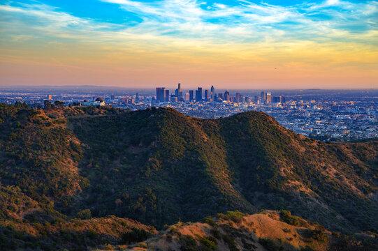 Sunset view of Griffith Observatory and the Los Angeles skyline from Mount Lee, with Hollywood Hills in the foreground.